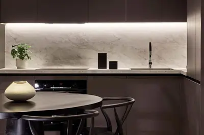 a kitchen with a table and a sink at Athens Metropolitan Grand Residence in Athens