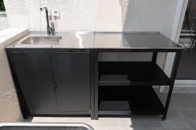 a black cabinet with a sink in a room at Sunny & Luxurious Penthouse with Terrace in Athens