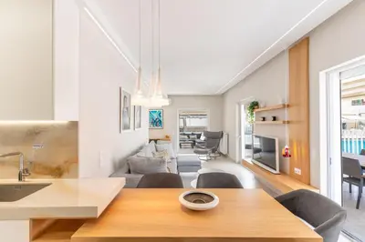a kitchen and living room with a table and chairs at Sunny & Luxurious Penthouse with Terrace in Athens
