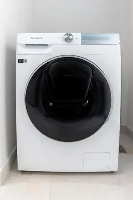 a white washing machine with a black door at Sunny & Luxurious Penthouse with Terrace in Athens