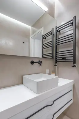 a bathroom with a white sink and a mirror at Sunny & Luxurious Penthouse with Terrace in Athens