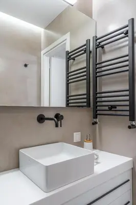 a bathroom with a white sink and a mirror at Sunny & Luxurious Penthouse with Terrace in Athens