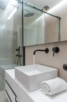 a bathroom with a white sink and a shower at Sunny & Luxurious Penthouse with Terrace in Athens