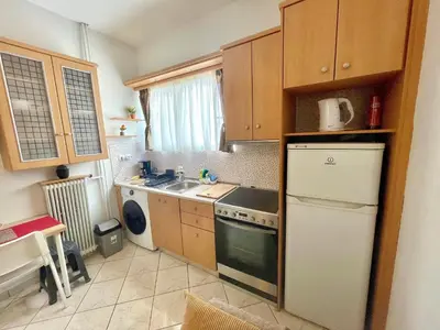 a small kitchen with a refrigerator and a sink at Modern & Quiet 4th Floor Flat - 3' from Metro in Athens