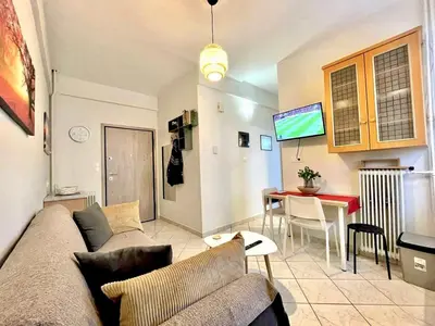 a living room with a couch and a table at Modern & Quiet 4th Floor Flat - 3' from Metro in Athens