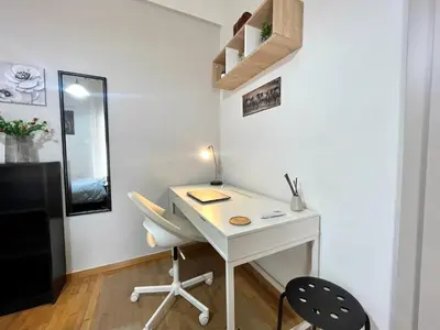 a desk in a room with a chair and a mirror at Modern & Quiet 4th Floor Flat - 3' from Metro in Athens
