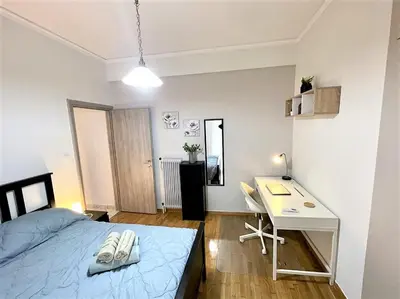 a bedroom with a desk and a bed and a desk and a desk at Modern & Quiet 4th Floor Flat - 3' from Metro in Athens