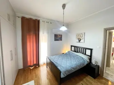 a bedroom with a bed in a room with a window at Modern & Quiet 4th Floor Flat - 3' from Metro in Athens