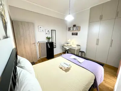 a bedroom with a bed and a sink in it at Modern & Quiet 4th Floor Flat - 3' from Metro in Athens