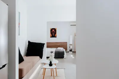 a living room with a couch and a table at Athena City Apartment in Athens