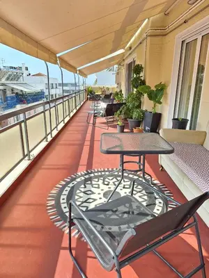 a balcony with tables and chairs on a building at Large 1 bedroom Penthouse with Large Terrace in Athens