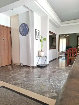 a lobby with a clock on the wall and a table at Large 1 bedroom Penthouse with Large Terrace in Athens