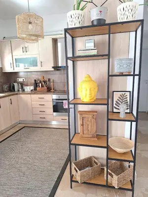 a kitchen with a book shelf with baskets and a table at Large 1 bedroom Penthouse with Large Terrace in Athens