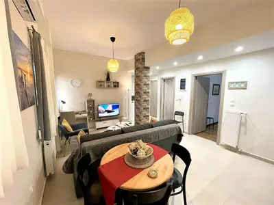 a living room with a couch and a table at Elegant & Modern Flat Near Panathenaic Stadium in Athens