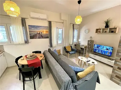 a living room with a couch and a table at Elegant & Modern Flat Near Panathenaic Stadium in Athens