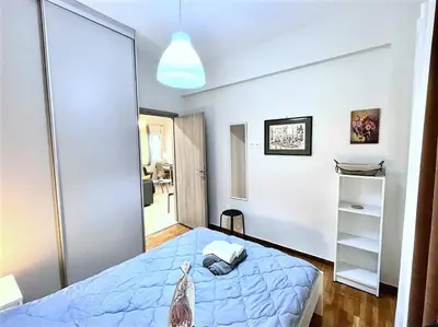 a bedroom with a blue bed and a mirror at Elegant & Modern Flat Near Panathenaic Stadium in Athens