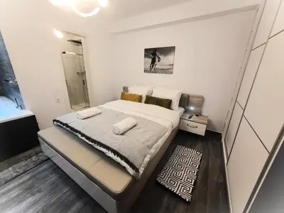 a bedroom with a large bed in a room at Jacuzzi Suite and Family Apartment Near Acropolis in Athens