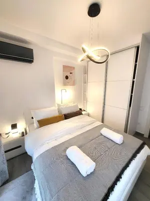 a bedroom with a large bed with a large window at Jacuzzi Suite and Family Apartment Near Acropolis in Athens