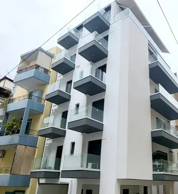 an apartment building with balconies on the side of it at Jacuzzi Suite and Family Apartment Near Acropolis in Athens