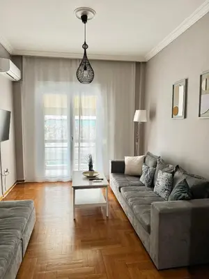 a living room with a couch and a table at Vivian modern apartment in Athens
