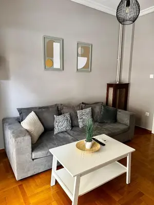a living room with a couch and a coffee table at Vivian modern apartment in Athens