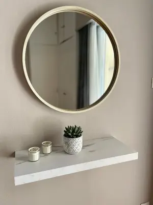 a mirror on a wall with a plant on a shelf at Vivian modern apartment in Athens