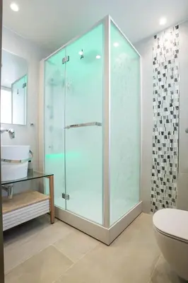 a bathroom with a glass shower and a sink at Mariet Athens Boutique Spa in Athens