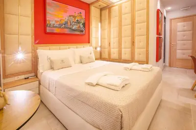 a bedroom with a bed with two towels on it at Mariet Athens Boutique Spa in Athens