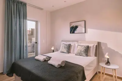 a bedroom with a bed with two towels on it at Villa Diamond in Lagonissi with pool & garden in Kalívia Thorikoú