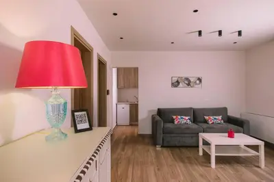 a living room with a couch and a red lamp at Villa Diamond in Lagonissi with pool & garden in Kalívia Thorikoú