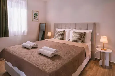 a bedroom with a large bed with two towels on it at Villa Diamond in Lagonissi with pool & garden in Kalívia Thorikoú