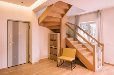 a staircase in a room with a chair and a table at Villa Diamond in Lagonissi with pool & garden in Kalívia Thorikoú