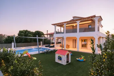 a villa with a swimming pool and a house at Villa Diamond in Lagonissi with pool & garden in Kalívia Thorikoú