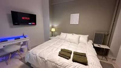 a bedroom with a white bed with two green towels on it at The NOTARY in Athens