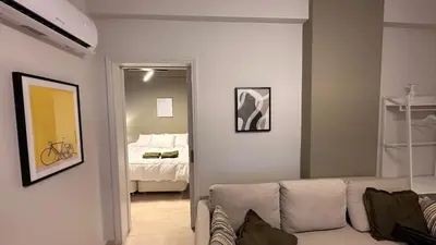 a living room with a couch and a bedroom at The NOTARY in Athens