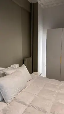 a white bed with white sheets and pillows at The NOTARY in Athens