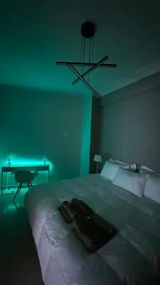 a bedroom with a large bed with a green light at The NOTARY in Athens