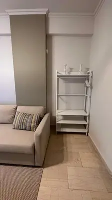 a living room with a couch and a shelf at The NOTARY in Athens