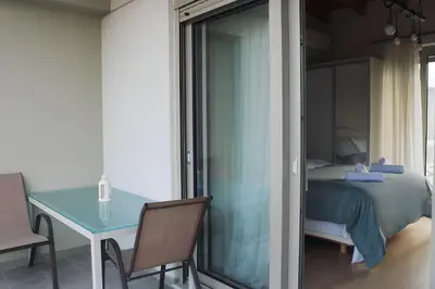 a bedroom with a blue table and a bed at Elizabeth Studio in Athens