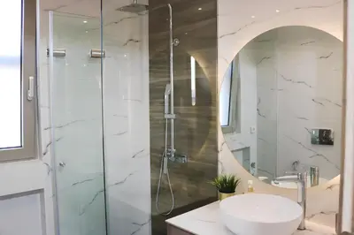 a bathroom with a sink and a shower at Elizabeth Studio in Athens