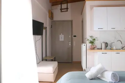 a kitchen and a living room with a bed and a table at Elizabeth Studio in Athens