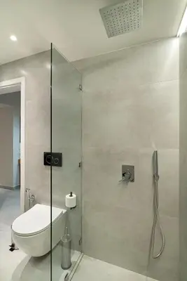 a bathroom with a toilet and a glass shower at Electra Urban Apartment Athens in Athens
