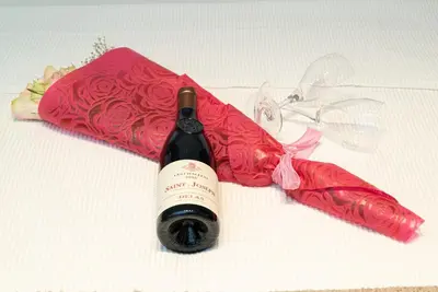 a bottle of wine sitting next to a red umbrella at Electra Urban Apartment Athens in Athens