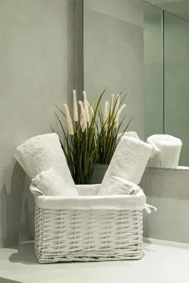a white wicker basket with a potted plant in it at Electra Urban Apartment Athens in Athens