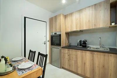 a kitchen with a table and a sink and a counter at Electra Urban Apartment Athens in Athens
