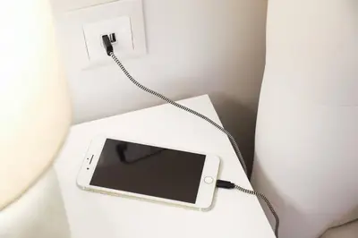 a cell phone on a table with a charger at Mikaella Residence in Athens