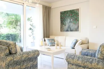 a living room with a couch and a table at Mikaella Residence in Athens
