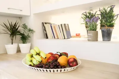a bowl of fruit on a counter in a kitchen at Mikaella Residence in Athens