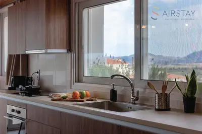 a kitchen with a sink and a window at Akali Apartment airport by Airstay in Spáta