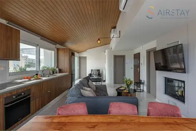 a living room with a couch and a table at Akali Apartment airport by Airstay in Spáta